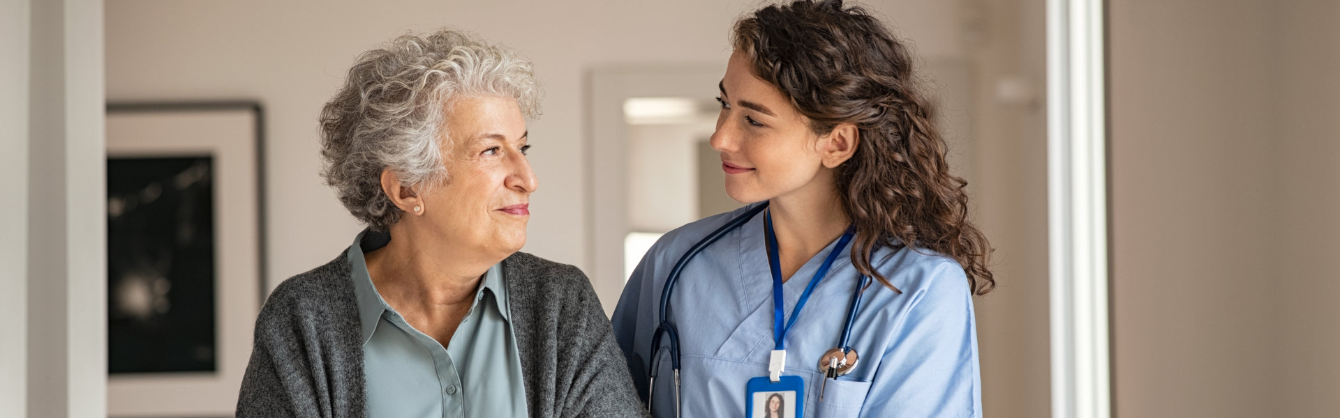 nurse and elderly woman looking at each other